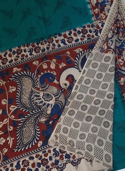 Green mul cotton kalamkari with peacock motif on pallu, border and body of saree.