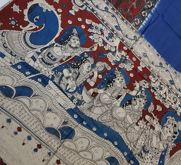 Blue and maroon half and half mul cotton kalamkari saree with peacock and human figure motifs.