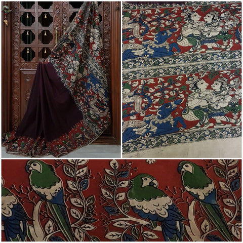 Maroon mul cotton kalamkari with intricate human figures and birds on pallu and border.