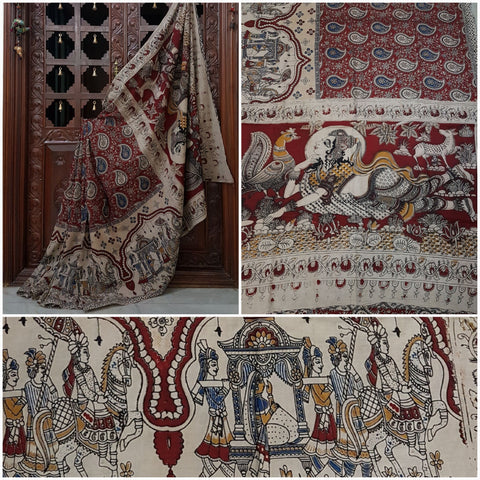 Maroon mul cotton kalamkari with a lady motif on pallu and wedding procession motif on border. The saree has paisley motif all over body.