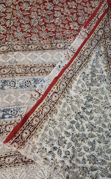 Mul cotton kalamkari half and half saree with contrasting maroon and off white colour combination. The saree has floral motif all over the saree.
