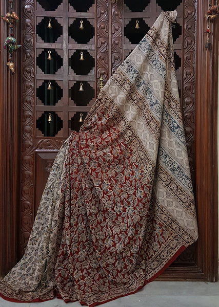 Mul cotton kalamkari half and half saree with contrasting maroon and off white colour combination. The saree has floral motif all over the saree.