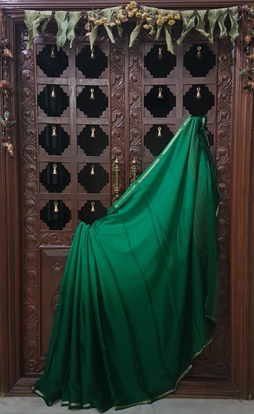 Two tone Bottle green 40 gms pure silk crepe. Saree comes with lighter shade silk crepe blouse piece.