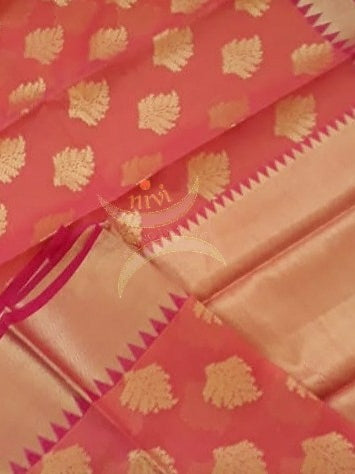 Dark peach cotton blend benaras brocade with antique zari motif on body, pallu and temple border. The saree comes with blouse piece matching pallu.
