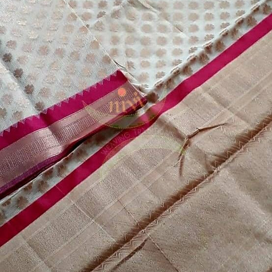 Off white silk cotton benaras brocade with ganga jamuna border and antique zari woven motifs. The saree comes with blouse piece matching saree body.