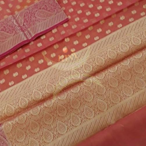 Orange shot peach silk cotton benaras brocade with antique zari paisley and floral motif.