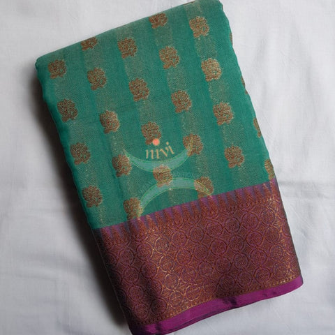 Teal benaras brocade with contrasting border and pallu