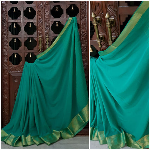 Sea green crepe art silk with zari border.