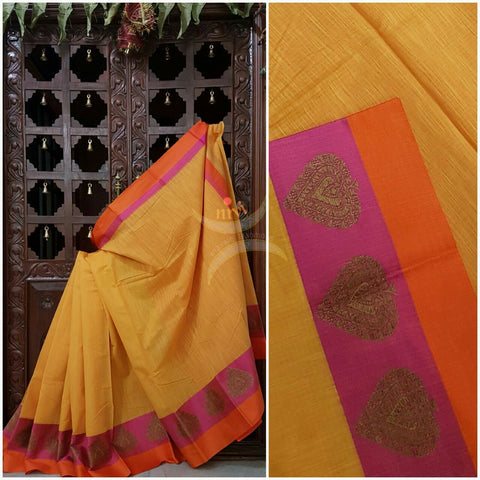 Yellow mercerised cotton saree with satin finish contrasting pink and orange border and pallu