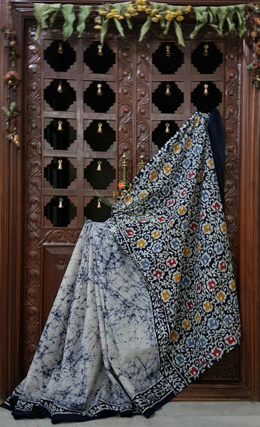 Grey off white handloom Mul Cotton Batik saree with floral motif on contrasting navy blue border and pallu