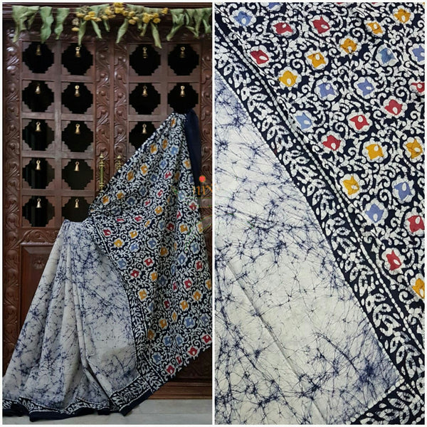 Grey off white handloom Mul Cotton Batik saree with floral motif on contrasting navy blue border and pallu
