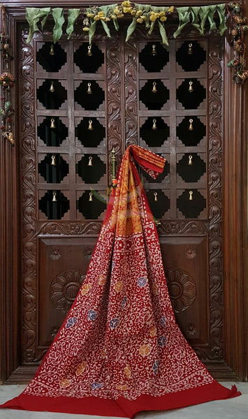 Orange handloom Mul Cotton Batik saree with contrasting floral motif red border and pallu