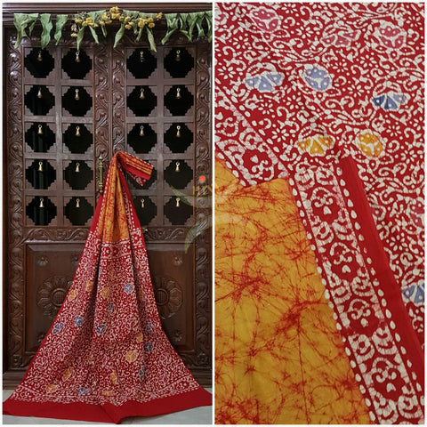 Orange handloom Mul Cotton Batik saree with contrasting floral motif red border and pallu