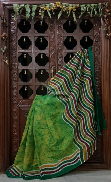 Green handloom Mul Cotton Batik saree with contrasting wavy motif on border and pallu