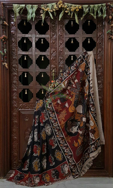 Black Chennur silk kalamkari with kathakali faces on body and border and lady figure on the pallu.
