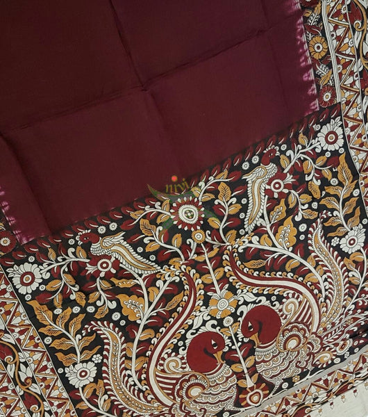 Maroon dye on dye chennur silk kalamkari with intricate peacock motif on pallu and abstract motif on border.