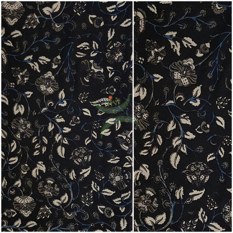 Black handwoven cotton kalamkari material with floral motifs.