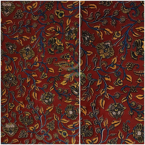 Red handwoven cotton kalamkari material with floral motifs.