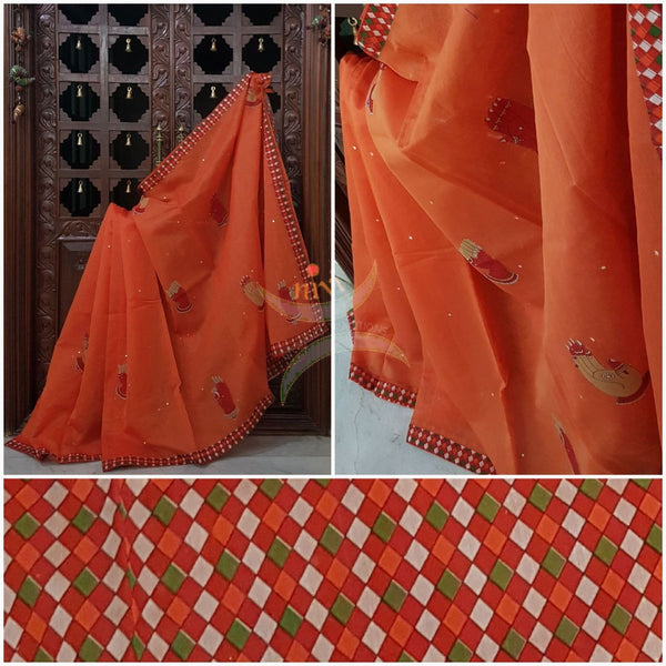 Orange supernet saree with hand mudra kalamkari motif applique on body and kalamkari border to match blouse.