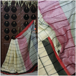 Off white Handloom 100s count Linen saree woven with chequered pattern and contrasting black red border and pallu. Saree comes with striped grey blouse. 