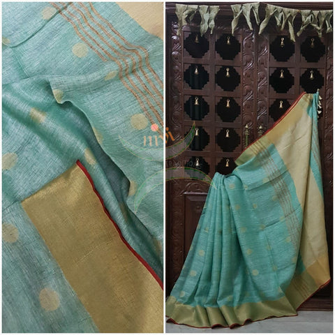 Sea green with gold Handloom 100s count Linen saree with woven booties all over the saree and gold pallu.