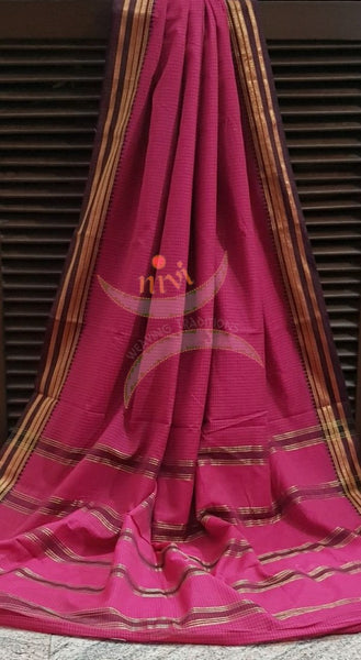Fuschia pink cotton blended checks with contrasting brown temple border and striped pallu.