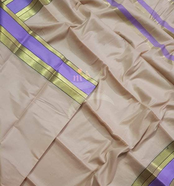 Beige cotton blend saree with contrasting purple border and thin stripes on pallu.