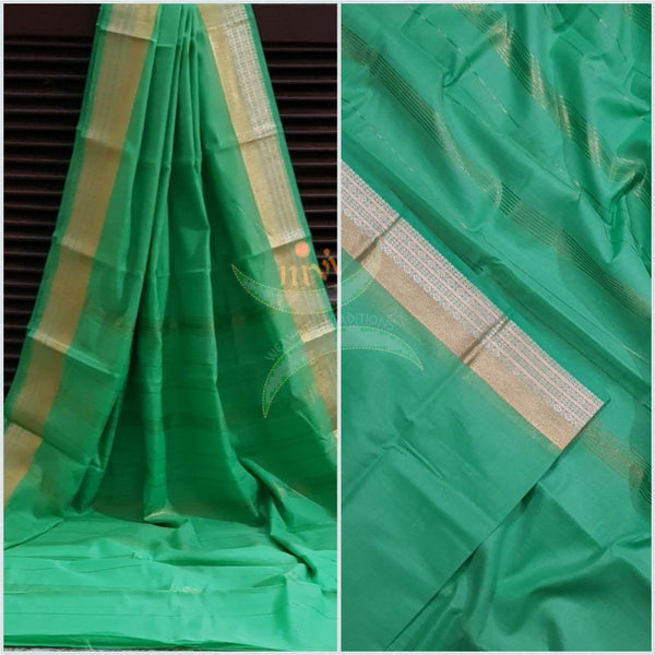Sea green cotton blend saree with subtle gold and silver zari border and thin stripes on pallu.