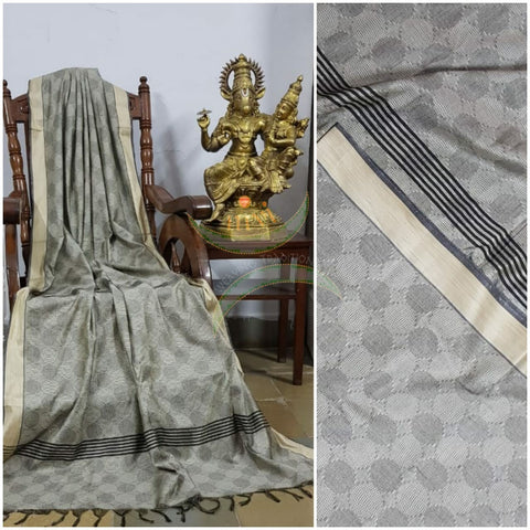 Grey Bengal handloom cotton tussar with all over jacquard weaving. Saree comes with running blouse.