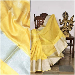 Yellow handloom linen with subtle silver border and silver strips on pallu.