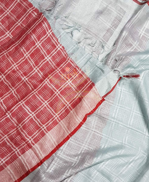 Silver grey handloom linen with self grey checks and self chequered striped pallu. Saree comes with contrasting red striped blouse piece.