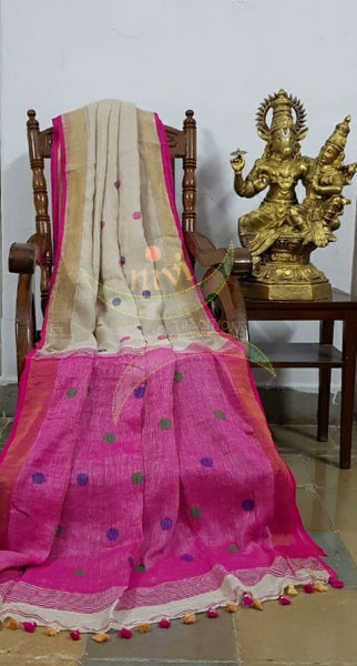 Cream handloom linen with polka dots and contrasting fuschia pink border, pallu and blouse.