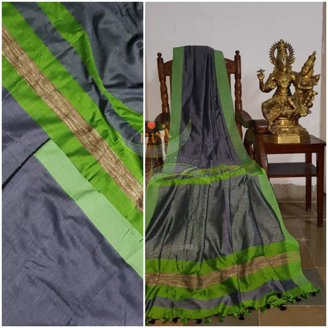 Grey handloom linen blend with contrasting green border and geecha pallu. Saree comes with contrasting green blouse.