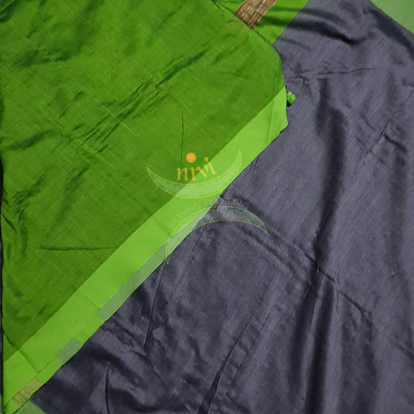 Grey handloom linen blend with contrasting green border and geecha pallu. Saree comes with contrasting green blouse.