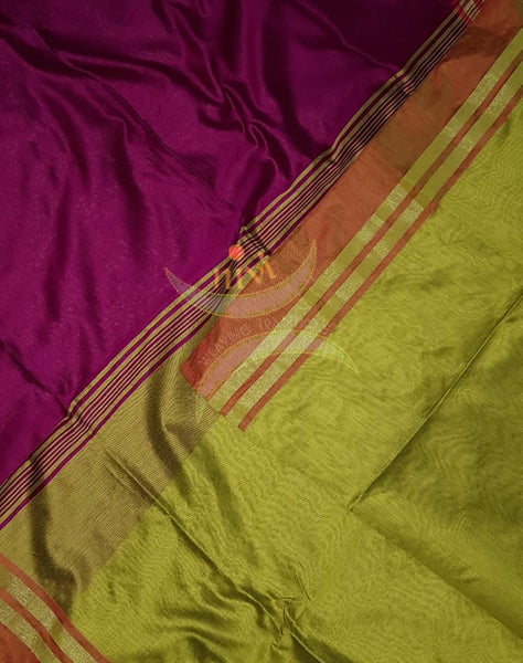 Magenta Bengal handloom cotton blend with multi coloured border and contrasting green pallu and blouse.
