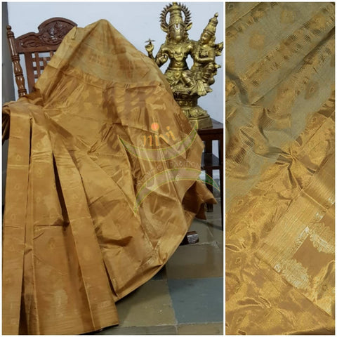 Golden brown Art silk tussar with zari motif on pallu and border. Saree comes with running blouse piece