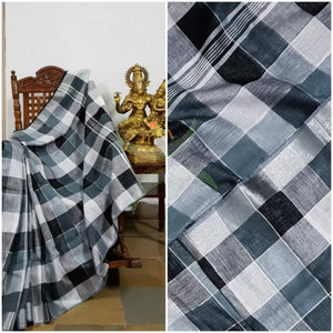 Black, white, grey multi coloured checkered linen with subtle silver border and strips on pallu. Sarees comes with running blouse.