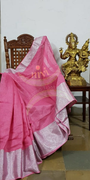 Pink pure linen with subtle silver borders and striped pallu. The Saree comes with running blouse.
