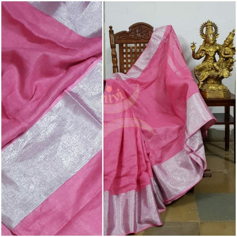 Pink pure linen with subtle silver borders and striped pallu. The Saree comes with running blouse.
