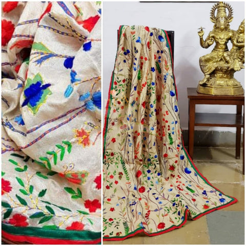 Hand embroidered kantha dupattas on beige art silk with multicoloured floral motif and red and green piping on the edges.