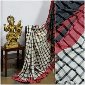 Black and white gamacha cotton with contrasting red border, black pallu and blouse.