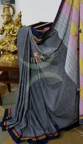 Grey handloom cotton with contrasting multicoloured border, pompoms on pallu  and running blouse.