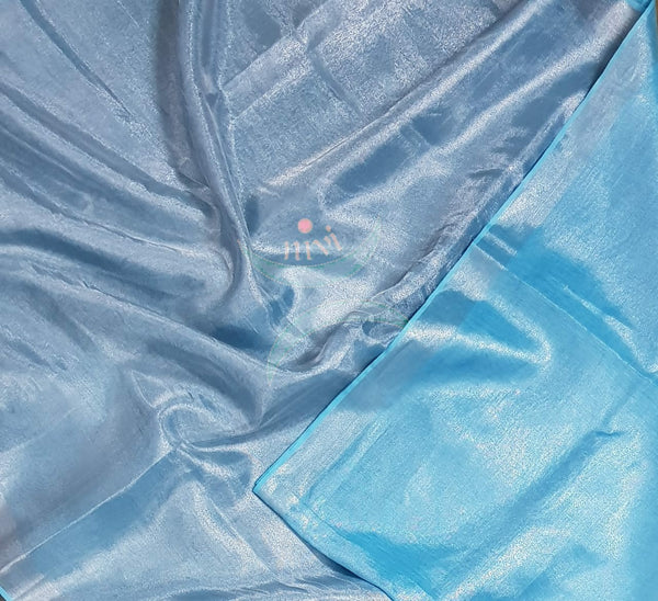 Light blue handloom tissue linen with silverish grey border. The saree comes with running blouse.