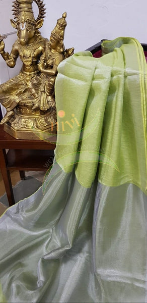 Light green handloom tissue linen with silverish grey border. The saree comes with running blouse.