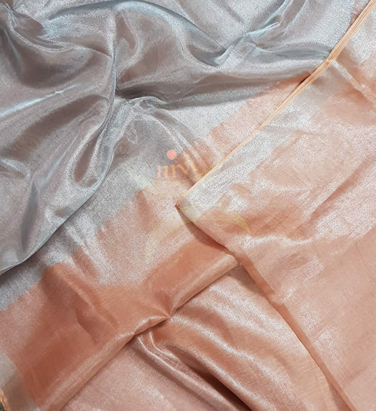 Light peach handloom tissue linen with silverish grey border. The saree comes with running blouse.