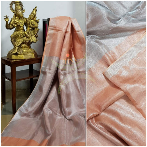 Light peach handloom tissue linen with silverish grey border. The saree comes with running blouse.