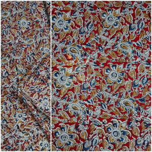 Red handloom cotton kalamkari fabric with floral motifs.
