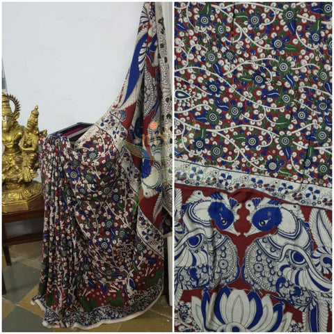 Maroon red handloom chennur silk kalamkari with floral motif on body and  peacock motif on pallu. Saree comes with kalamkari printed blouse piece.