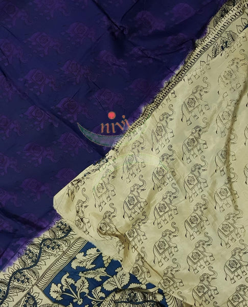 Royal blue handloom chennur silk kalamkari with purple elephant motif on body and peacock motif on pallu. The Saree comes with kalamkari printed blouse piece.
