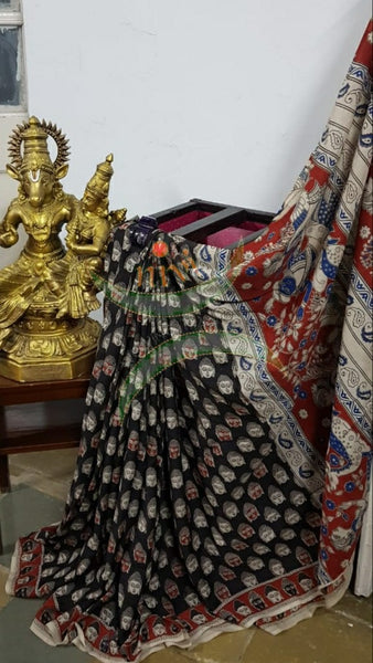 Black handloom chennur silk kalamkari with Buddha face motif on body and mythological human motif on pallu. The Saree comes with kalamkari printed blouse piece.